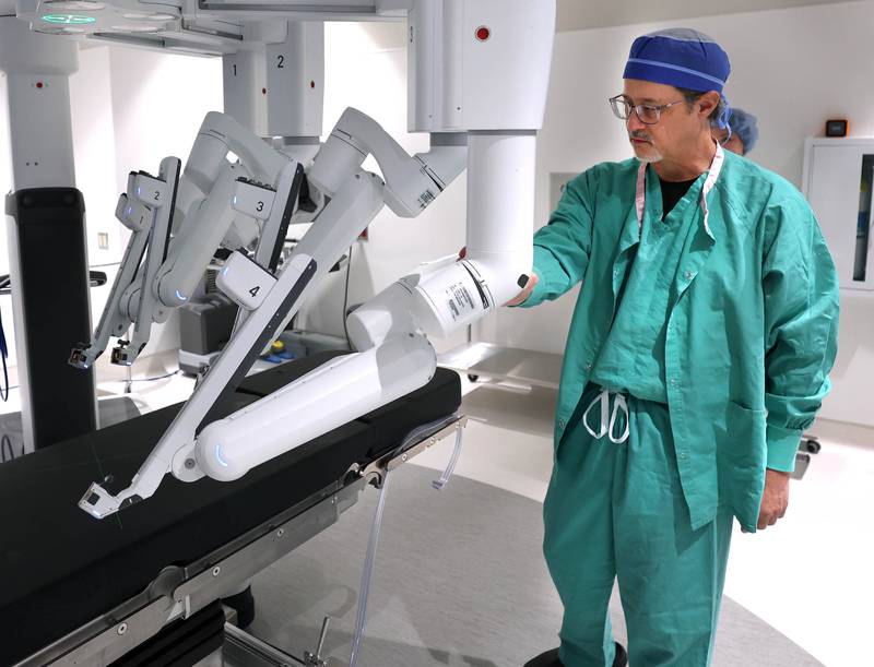 Dr. Jack Wagoner, associate chief medical officer at Northwestern Medicine Kishwaukee Hospital, rotates the da Vinci Xi robotic surgical system into position Tuesday, Oct. 28, 2025, in one of the operating rooms at the hospital in DeKalb. The hospital recently celebrated its 2,000th successful robotic-assisted surgery.