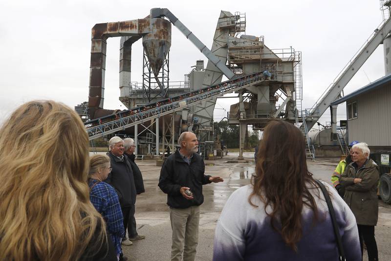 Rob Baker talks about Peter Baker & Son’s asphalt plant during the McHenry County Sand and Gravel Mining Tour on Thursday, Oct. 12, 2023. The tour brought McHenry County board members, township and village officials on a four hour trip to visit operating mines on Route 23 in Marengo and to former sites now reclaimed for housing, recreation in Algonquin and Cary.