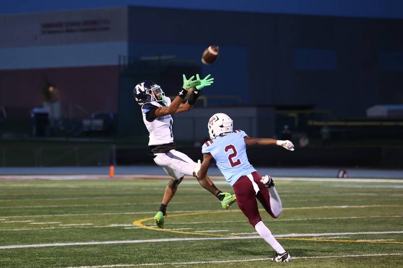 Nazareth's Trenton Walker catches the pass ahead of Kankakee's Ezekiel Sherrod during Kankakee's 33-12 loss to Nazareth on Friday, Aug. 29, 2025.