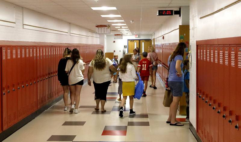 Students and parents walk the halls of Duker Elementary School in McHenry, on Tuesday, Aug. 15, 2023, as students were able to put items in their desks and meet their teachers while they prepare for the first day of school on Wednesday, Aug. 16, 2023.