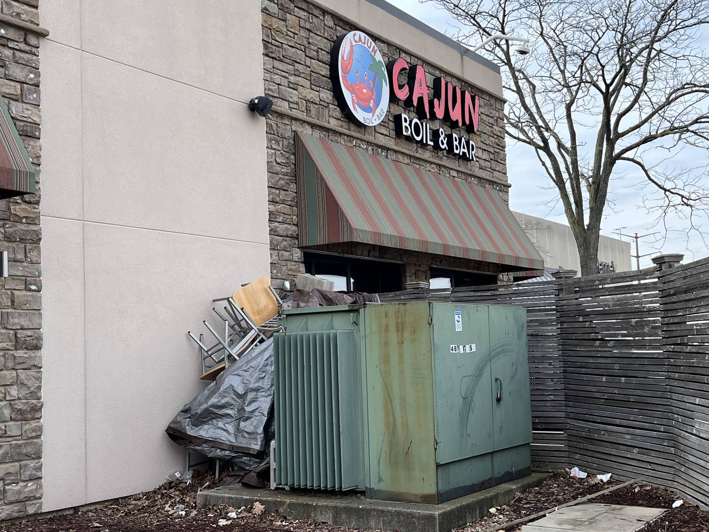 Furniture stacked up outside the patio area of Cajun Boil & Bar, 3340 Mall Loop Drive, Joliet, seen on Wednesday, Feb. 8, 2023.