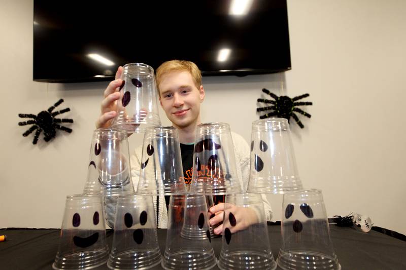 Ryan Kufner, 17, a volunteer with the National Honor Society from Grayslake Central High School, gets the Ghost Stack-Up game ready to play during Witchy Thrills & Chills at the Lindenhurst Park District Lippert Community Center on October 14th in Lindenhurst.
Photo by Candace H. Johnson for Shaw Local News Network