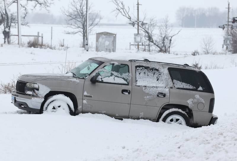 A snow-covered vehicle sits in a ditch Friday, Jan. 12, 2024, on Route 30 west of Hinckley. Several inches of snow blanketed DeKalb County Friday on top of the 6 inches that fell on the area earlier this week.
