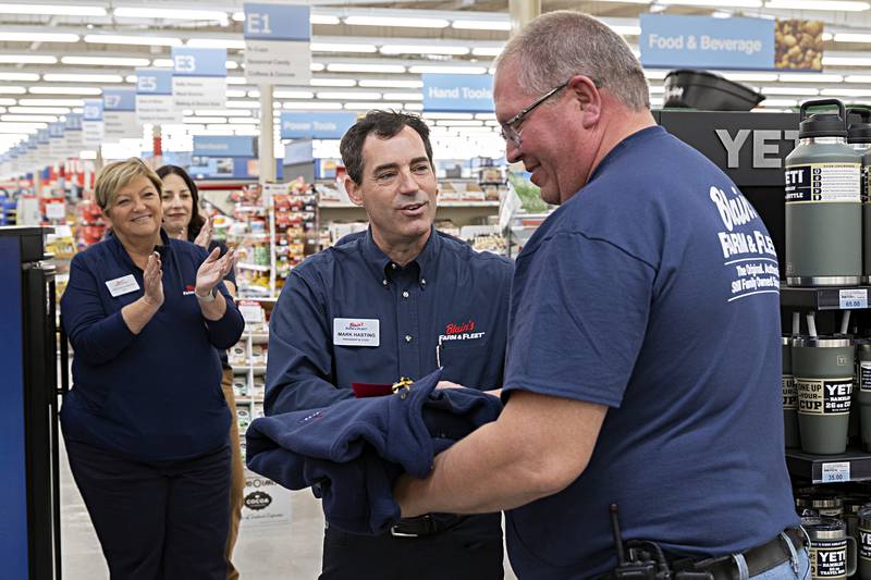 Mark Hasting, president and COO of Blain’s Farm and Fleet, presents a gift to Dan Heslop, manager of the Sterling store Thursday, Nov. 9, 2023. The store is celebrating 65 years at the Sterling location and Heslop is celebrating 40 years as employee.