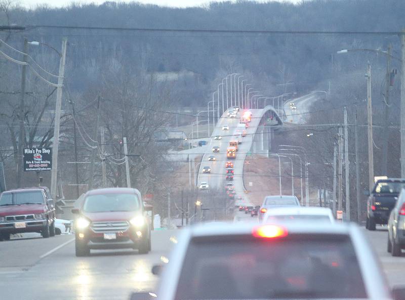 A procession of school busses and parents parade through Spring Valley with the JFK seventh-grade girls basketball team on Thursday, Dec. 12, downtown Spring Valley. The Wildcats will face Mt. Sterling Brown County in the IESA Class 2A State Championship.