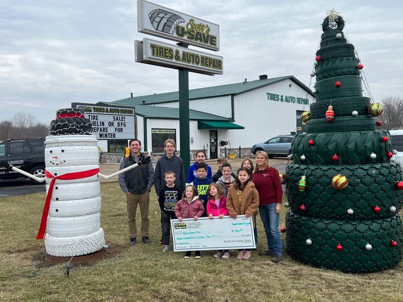 Scott’s U-Save Tires & Auto Repair donated $750 to the PTO at New Lenox School District 122 as part of its holiday contest this year. Brad Templin, Scott’s U-Save Tires & Auto Repair  operations manager is on the left, and Sheri Templin,  Scott’s U-Save Tires & Auto Repair owner, is on the right.