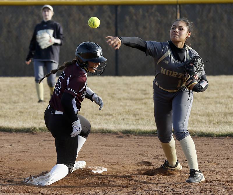 Grayslake North’s Alyson Alvarenga tries to turn a double play as Prairie Ridge’s Mary Myers slides through the ball during a nonconference softball game Thursday. March 23, 2023, at Grayslake North High School.