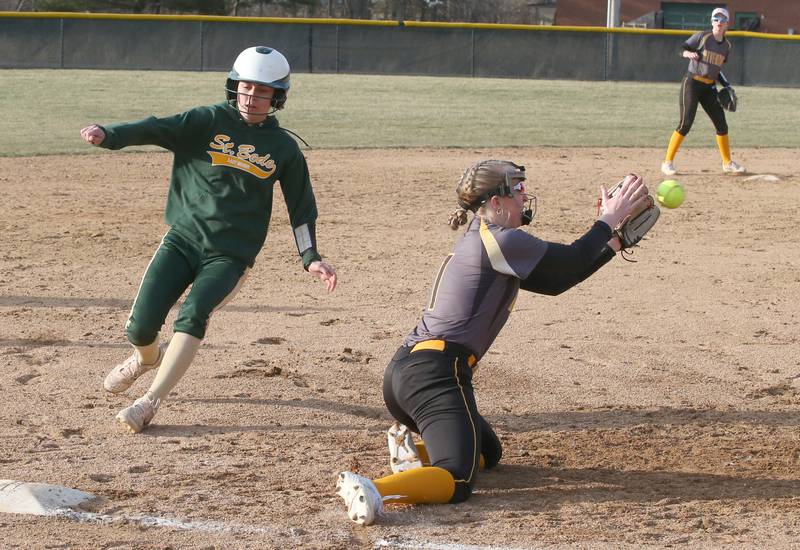 St. Bede's Kailey Moore runs in safely to third base as Riverdale's Lexi Duke makes a late catch on Monday, March 20, 2023 at St. Bede Academy.
