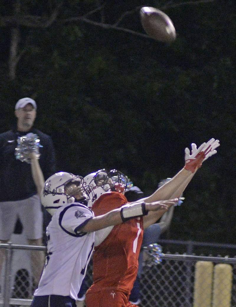Lisle's Casey Rosenberg (15)_ and Streator’s Matt Williamson (7) reach for a pass Friday, Sept. 16, 2022, at Doug Dieken Stadium in Streator.