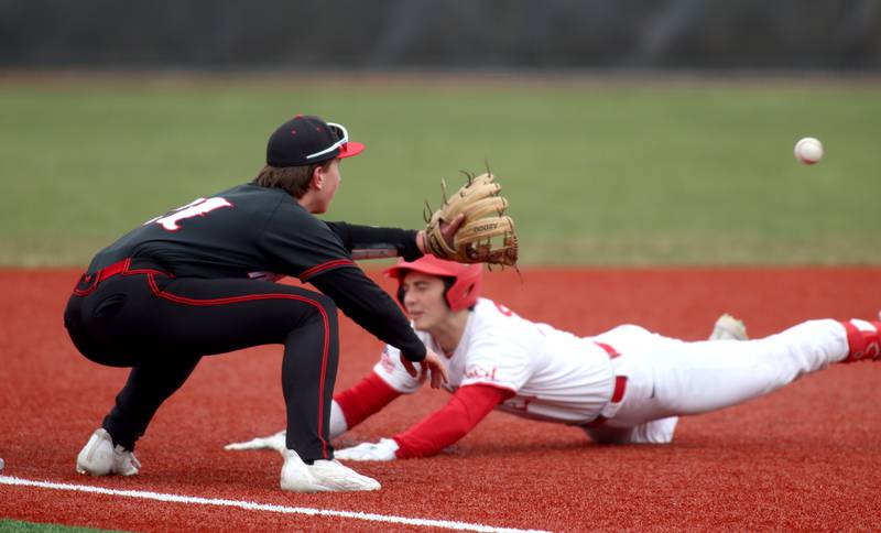 Barrington’s Julian Ashley-Friedman arrives safely at third base with a triple as Huntley’s Marco Stawski fields the cut-off throw in varsity baseball at Barrington Saturday.