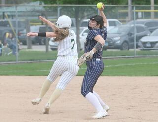 Marquette's Makayla Backos forces out St. Bede's Maci Kelly while throwing to first base on Thursday, April 18, 2024 in Ottawa.
