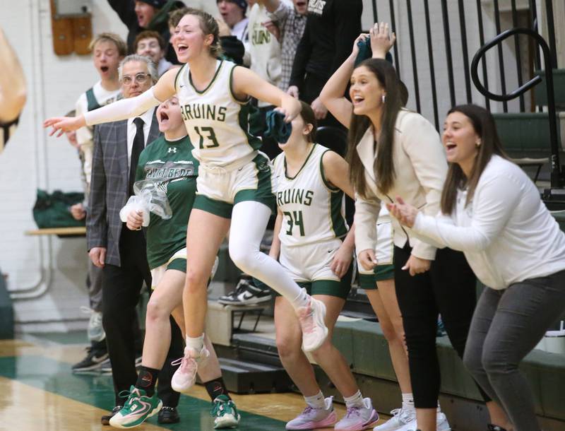 St. Bede's Ashlyn Ehm reacts to teammate Parker McClain sinking a buzzer-beater shot at the end of the first half against Marquette on Monday, Dec. 2, 2024 at St. Bede Academy.