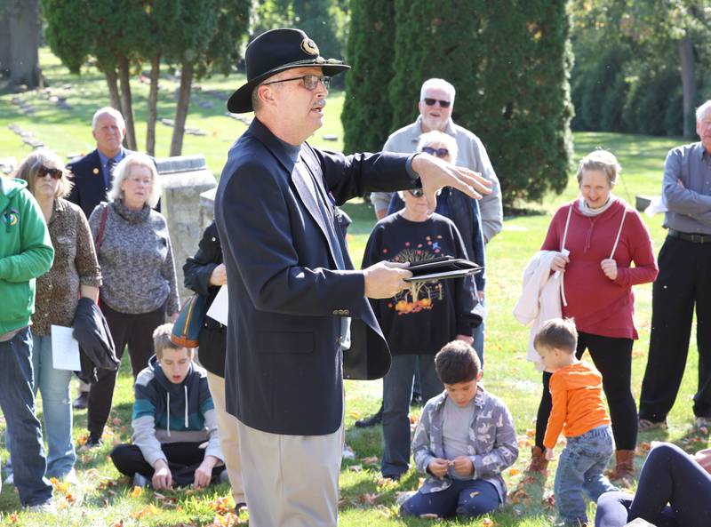 Volunteer Lars Jacobson, talks to visitors Sunday, Oct. 9, 2022, at Elmwood Cemetery in Sycamore, at the grave of Reverend Sorenson, who was an early reverend at St. Peter's Episcopal Church, during the Etched in Stone cemetery walk. The event, hosted by the DeKalb County History Center, told the stories of some local individuals who are buried there.