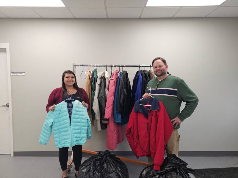 Christine Mendez and Eric Fisher, of We Care, with the coats collected for the Grundy Bank coat drive.