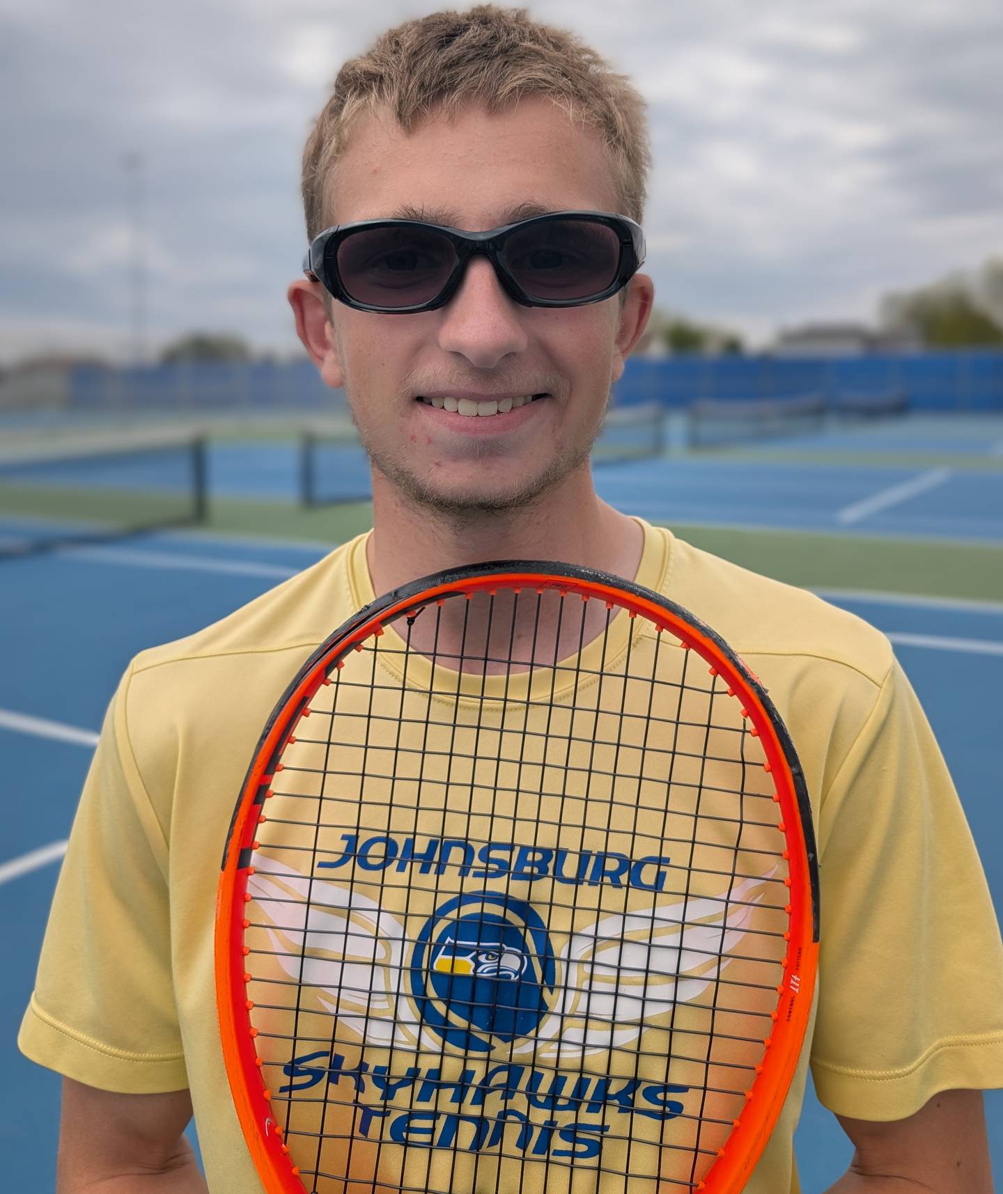 Johnsburg senior Tyler Batt poses for a picture on his home tennis court Saturday, May 9, 2026, in Johnsburg. The four-year varsity player is undefeated this season.