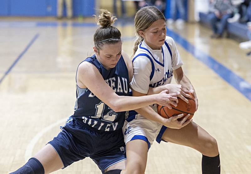 Bureau Valley’s Kate Stoller grapples with Newman’s Elaina Allen for the ball Thursday, Nov. 30, 2023 in Sterling.
