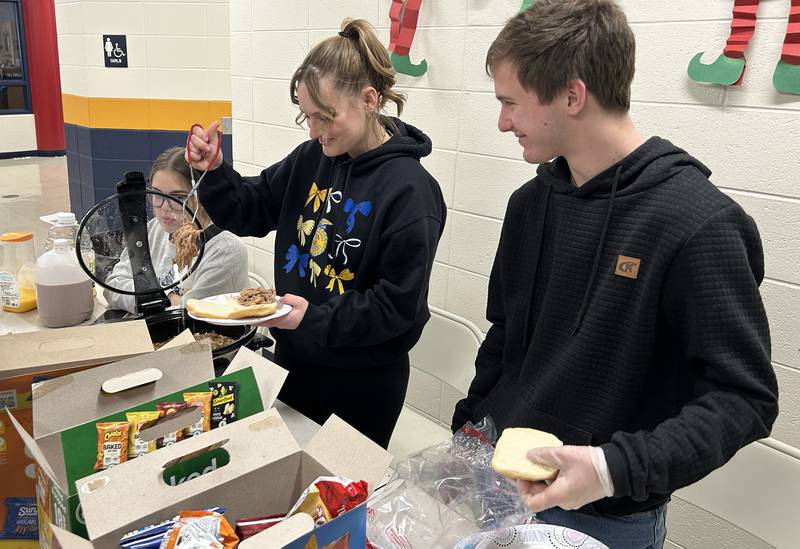 Polo FFA members Grade Wooden, Makayla Cicchetti, and Joey Rowland served up pulled pork sandwiches at the FFA booth at the Polo Christmas Festival's Craft and Vendor Show on Saturday, Dec. 6, 2025. The event was held at Centennial Grade School.