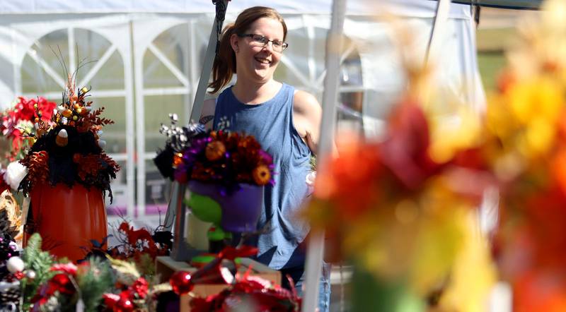 Brittany Rendant of Woodstock works with her mother Debbie as they sell seasonal floral arrangements during the 20th Annual Fall Fest at Deicke Park in Huntley on Sunday, September 28, 2025.