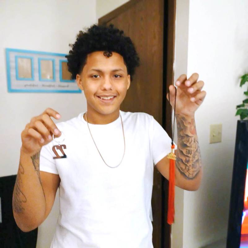 Diamonte Dailey, 17, of DeKalb, poses in January 2022 with his Class of 2022 items that his mother bought for him ahead of his expected graduation from Kishwaukee Education Consortium that spring. Dailey died from a fentanyl drug overdose April 3, 2022. Madison Ricke, of DeKalb, is charged with drug-induced homicide in his death. (Photo provided by Adriana DeMarco)