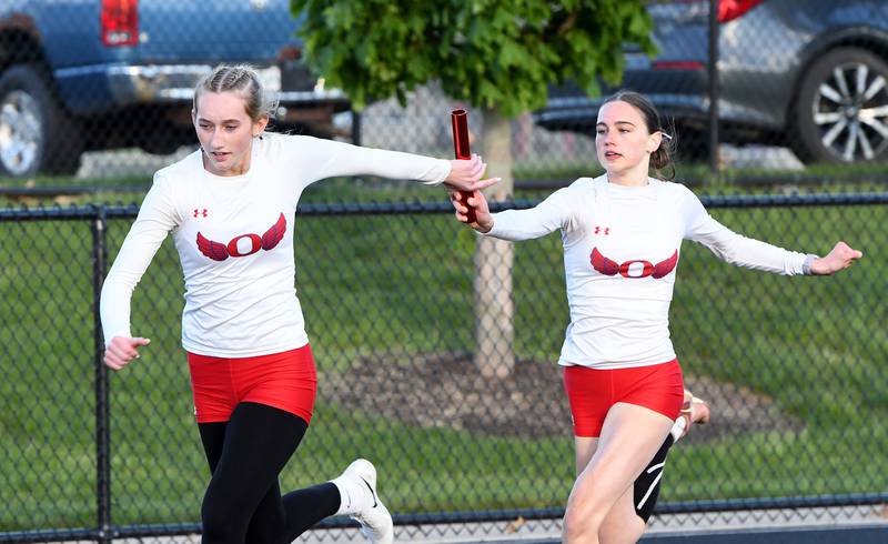 Oregon's Lorelai Dannhorn  hands the baton to Taylor Weems in the 4x200 relay at the 1A Winnebago Sectional on Wednesday, May 13, 2026. Oregon placed second in the event to advance to the state meet.