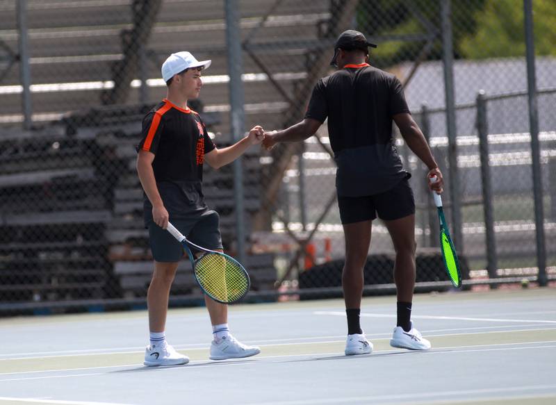 DeKalb doubles partners Rylan Lottes (left) and Matthew Williams shake hands during the first round of the 2A boys state tennis meet with doubles partner Jack Soto (not pictured) on Thursday, May 29. 2025 at Hersey High School.