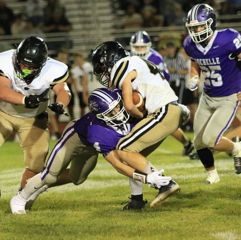 Rochelle's Gavin Neale (4) tackles a Lena-Winslow running back during Friday's game in Rochelle.