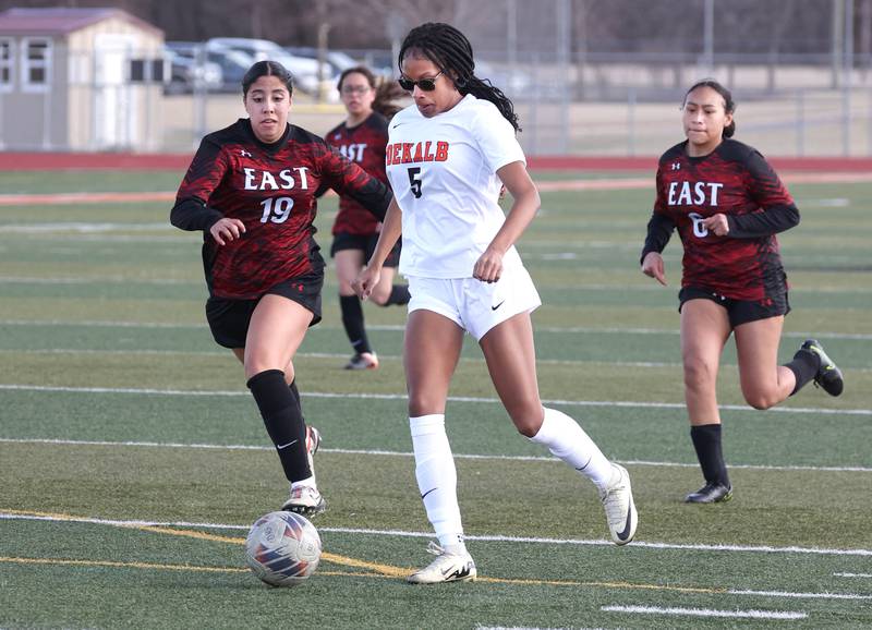DeKalb's Demi McNeil pushes the ball ahead of Rockford East's Sofia Gomez during their game Tuesday, March 25, 2025, in the Barb Fest tournament at DeKalb High School.