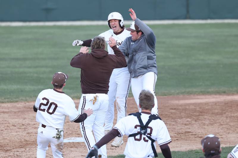 Joliet Catholic’s Jake Troyner celebrates with his teammates after a walk off single against Lockport on Wednesday, March 27, 2024 in Joliet.