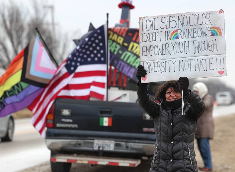 Lea Rizzi, from Genoa, protests Thursday, Feb. 5, 2026, in front of Genoa-Kingston High School. The group is protesting the “History Rocks” assembly which is part of a nationwide campaign by the U.S Department of Education tied to the nation’s 250th anniversary and organized by the high school’s Turning Point USA, Club America chapter, a nonprofit founded in 2012 by the late Charlie Kirk.