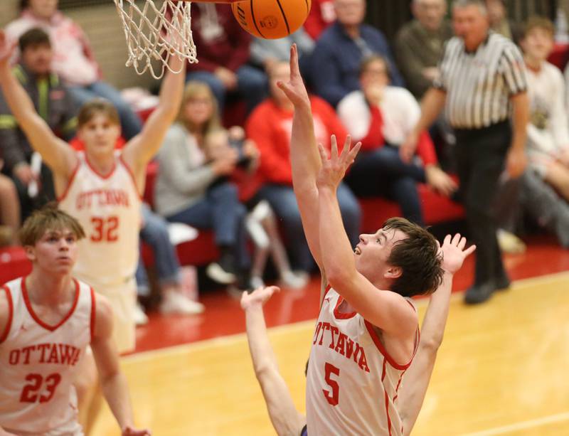 Ottawa's Kyler Araujo lets go of the ball underneath the basket against Plano during the Dean Riley Shootin' The Rock Thanksgiving Tournament on Tuesday, Nov. 26, 2024 in Kingman Gym at Ottawa High School.