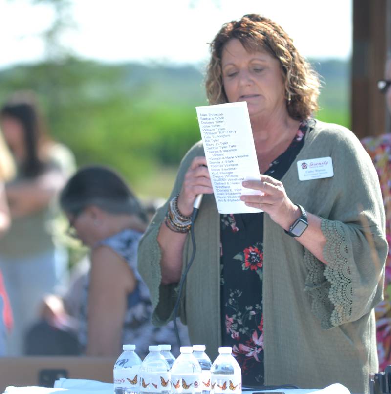 Cathy Warren, bereavement coordinator, reads from the list of names during Serenity Hospice & Home Memorial Butterfly Release on Saturday, July 8, 2023, in Oregon.