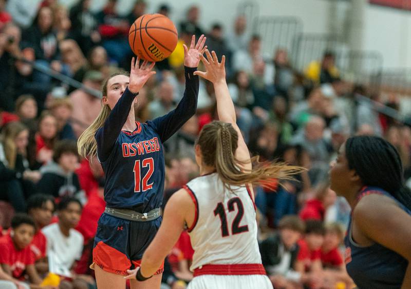 Oswego’s Emily Mengerink shoots a three-pointer against Yorkville's Katlyn Schraeder during the 13th annual Hoops 4 Hope Communities vs. Cancer basketball event at Yorkville High School on Saturday, Jan 28, 2023.