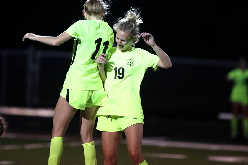 Richmond-Burton’s Margaret Slove, left, and Layne Frericks begin to celebrate as the clock ticks down on a win over Willows in Class 1A Sectional title soccer action at Richmond Friday night.