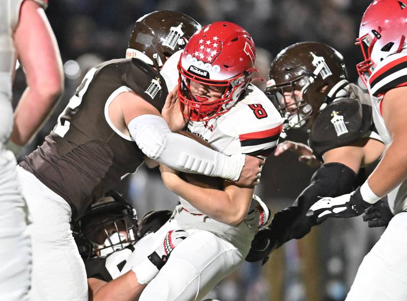 Jacksonville's Braden Hutchison (8) gets tackled by a host of Joliet Catholic's defenders during the IHSA Class 5A first round playoff game on Saturday, Nov 02, 2024 at Joliet. (Dean Reid for Shaw Local News)
