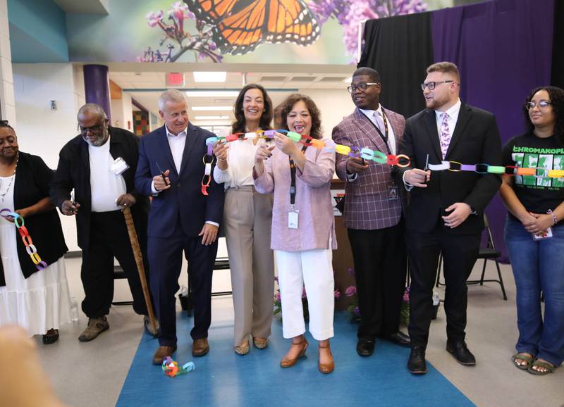 DeKalb city officials, representatives from DeKalb School District 428 and honorees cut the ribbon Friday, Aug. 8, 2025, during the grand opening celebration for Mitchell Elementary School in DeKalb.
