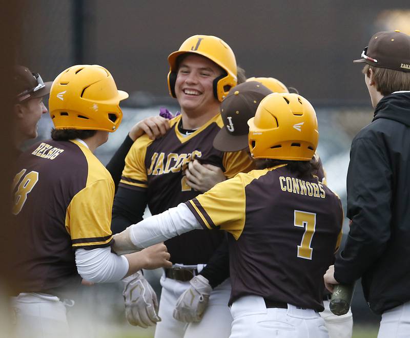 Jacobs’s Christian Graves is mugged by his teammates after he hit a game winning grand slam home run ball during a Fox Valley Conference baseball game Thursday, May 5, 2022, between Jacobs and Cary-Grove at Jacobs High School.