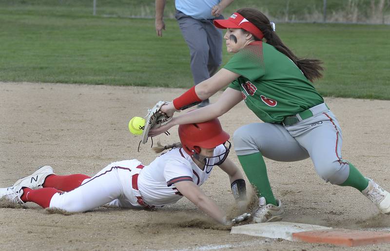 Ottawa baserunner Hailey Larsen dives back safely into first as La Salle-Peru second baseman Callie Mertes (6) covering the bag on a bunt attempt tries to gather in the throw at King Field on Monday, April 11, 2022.
