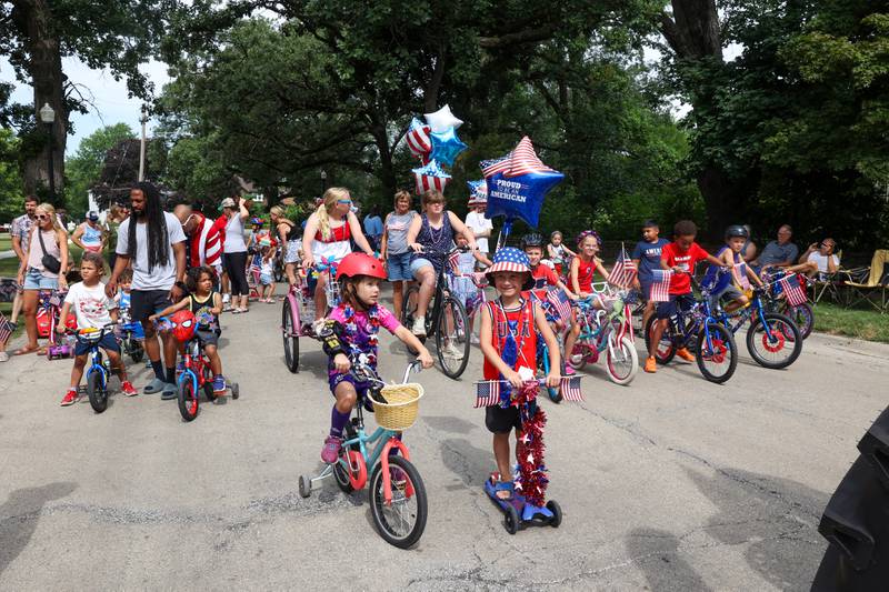 Ferne Holstein, 5, left center, and Max Cooke, 5, right center, wait to lead off the Kids' Bike Ride as Miss and Mister Firecracker during the Riverview Historic District's annual 4th of July Celebration on Friday, July 4, 2025.