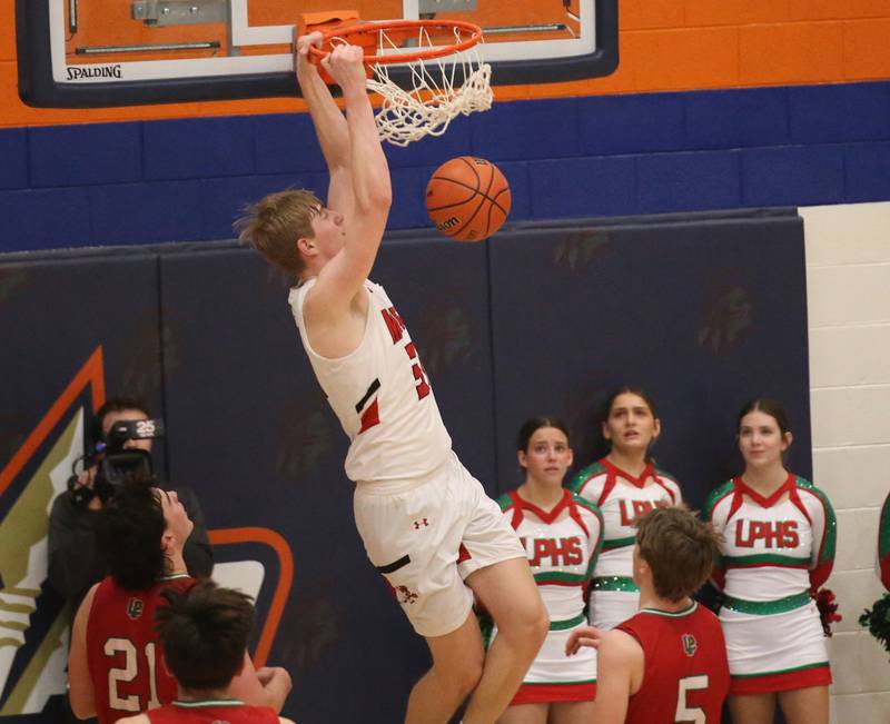 Metamora's Cooper Koch slams a dunk in front of  L-P's Josh Seneca and Seth Adams during the Class 3A Sectional on Tuesday, Feb. 27, 2024 at Pontiac High School.