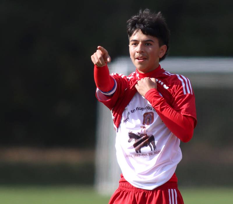 Dundee-Crown’s Mauricio Ruiz reveals a t-shirt under his jersey as he celebrates after scoring against St. Charles East in IHSA Class 3A Regional Championship soccer at Dundee-Crown High School in Carpentersville on Saturday, October 25, 2025.