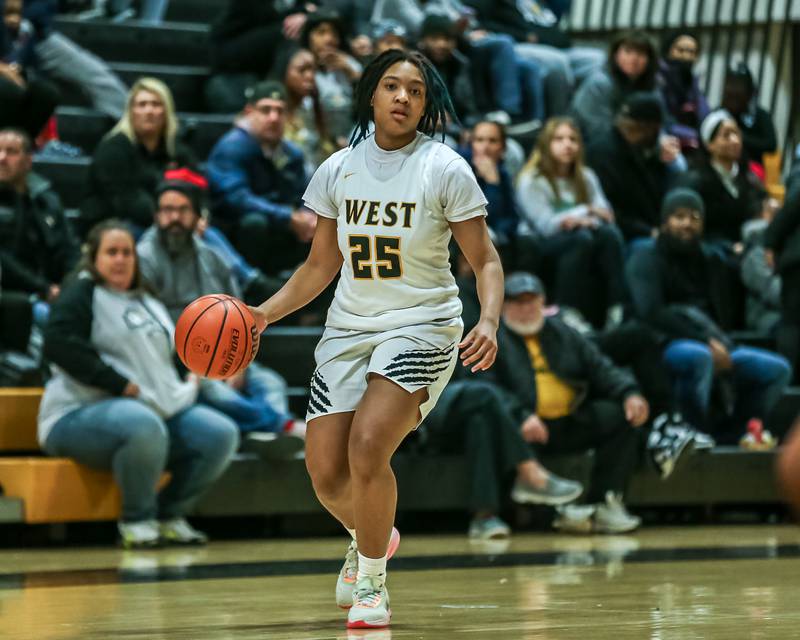 Joliet West's Maziah Shelton (25) advances the ball during basketball game between Providence Catholic at Joliet West. Dec 18, 2023.