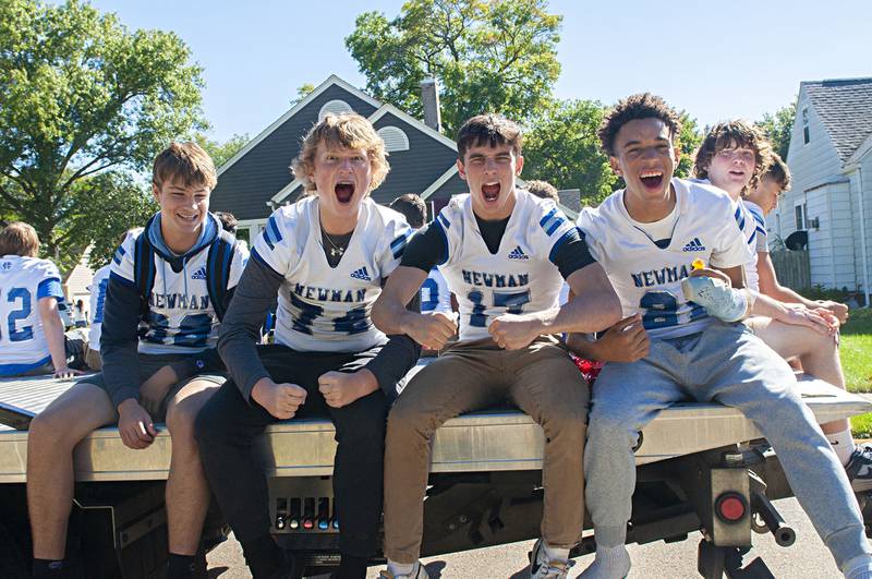 Newman footballers cheer from their float during the school’s homecoming parade Friday, Sept. 30, 2022. The Comets will take on Princeton tonight in football.