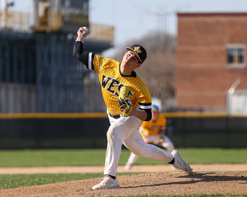 Joliet West's Juan Rico (3) throws a pitch during varsity baseball game between Oswego East at Joliet West.  April 10, 2023.