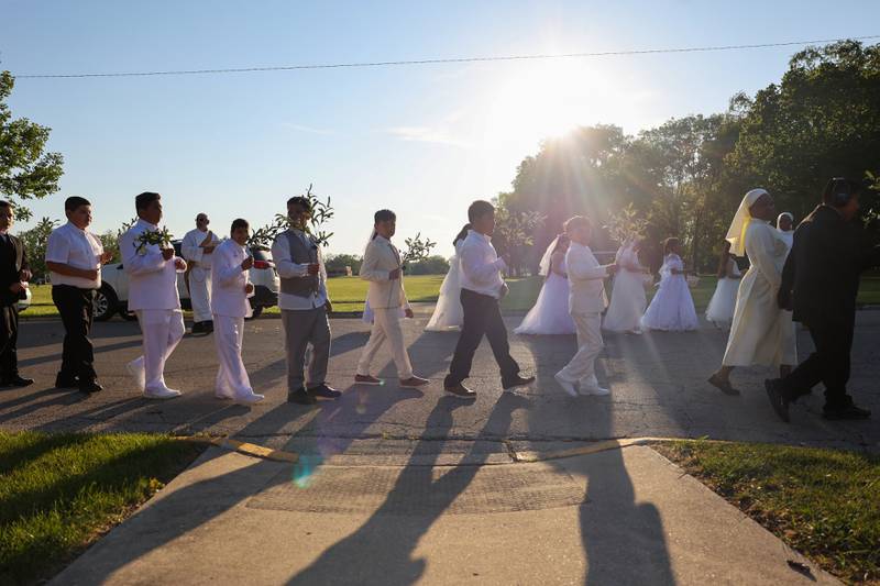 Young parishioners carry olive branches in the procession as part of the National Eucharistic Pilgrimage stop at St. John Paul II Catholic Church in Kankakee on Sunday, May 18, 2025.