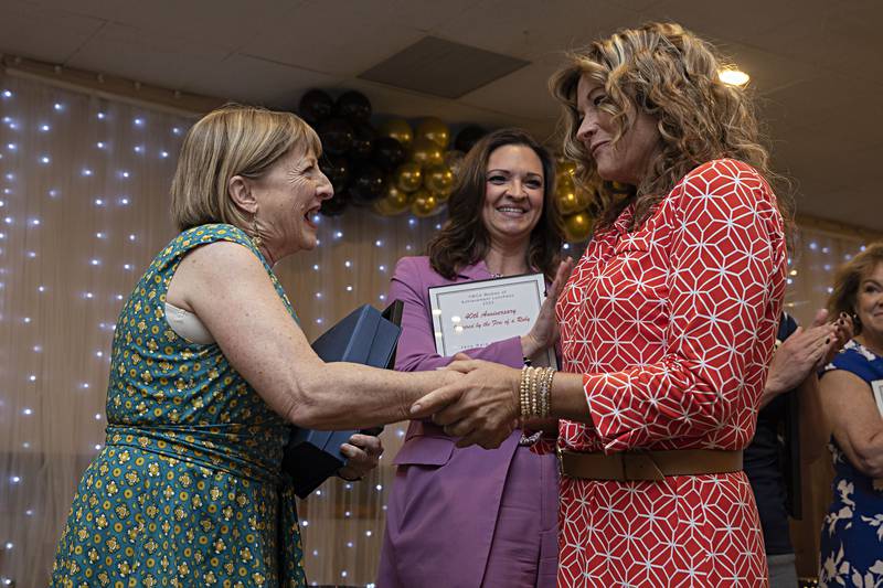 Linda Hellmich (left) thanks YWCA staff member Laura See after being named the recipient of the Jane Reid Keefer Award for Professions and Education Thursday, April 13, 2023 at the YWCA Women of Achievement Luncheon.
