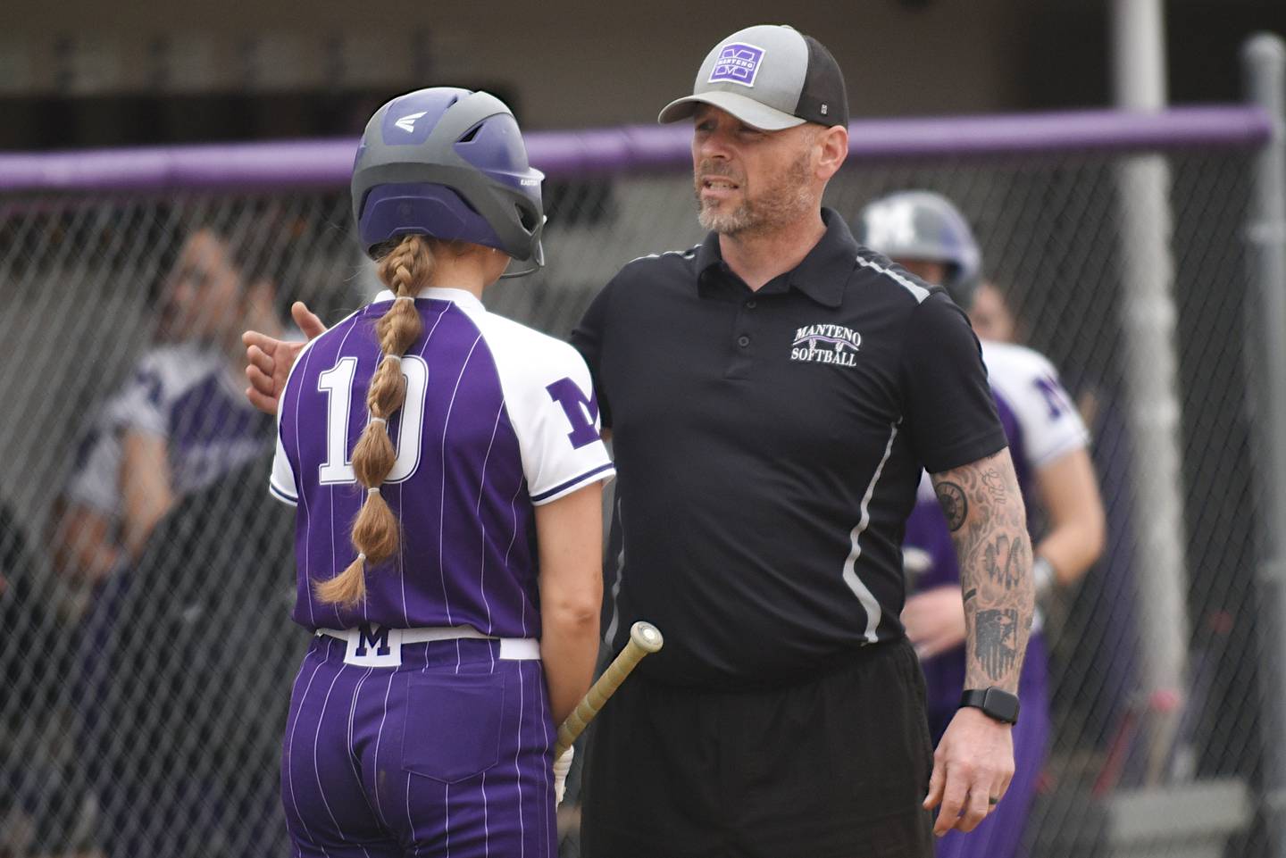 Manteno softball coach Josh Carlile, right, talks to Ayssa Singleton moments before Singleton delivered the walk-off double in the Panthers' 6-5 home win over Pontiac Friday, April 3, 2026.