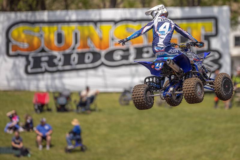 Professional rider Cody Ford gestures at the audience while midair during the ATVMX Championship race on May 24, 2025 at Sunset Ridge MX in Walnut.