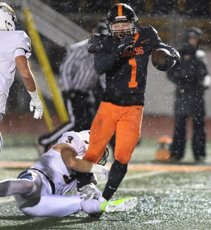 DeKalb's Talen Tate tries to break away from Neuqua Valley's Josh Wenz during their game Friday, Oct.14, 2022, at DeKalb High School.