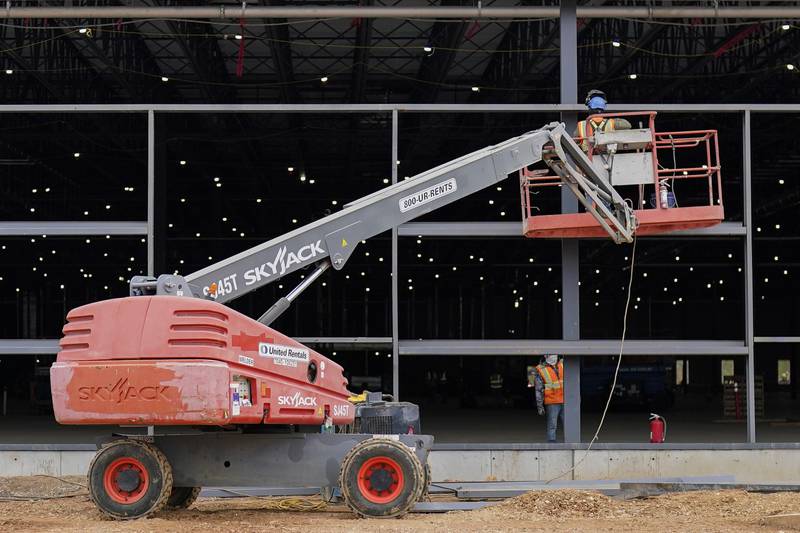 A Sky Jack lift is operated outside a Hanwha QCells Solar plant, Monday, Oct. 16, 2023, in Cartersville, Ga. On Thursday, the Commerce Department issues its first of three estimates of how the U.S. economy performed in the third quarter of 2023. (AP Photo/Mike Stewart)