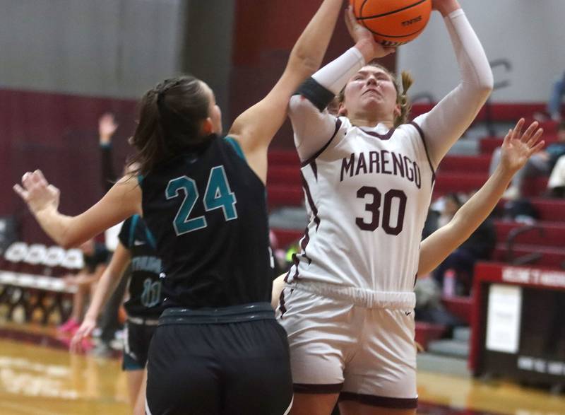 Marengo’s  Macy Noe works under the hoop against Woodstock North in varsity girls basketball on Tuesday, Dec. 2, 2025, at Marengo High School in Marengo.